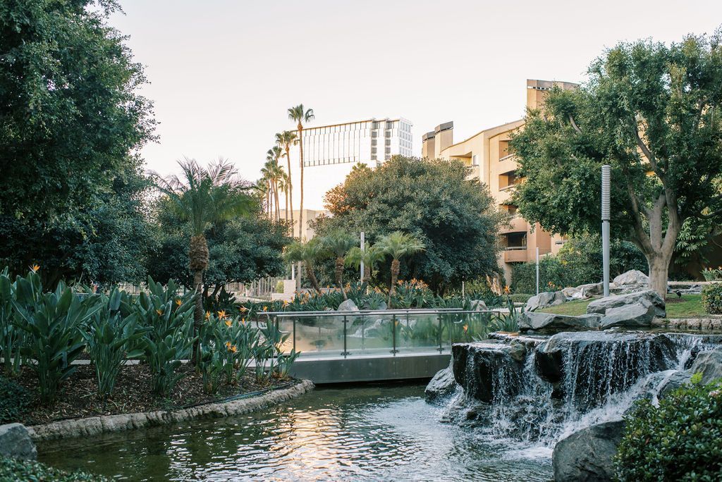 There is a waterfall in the middle of a park.