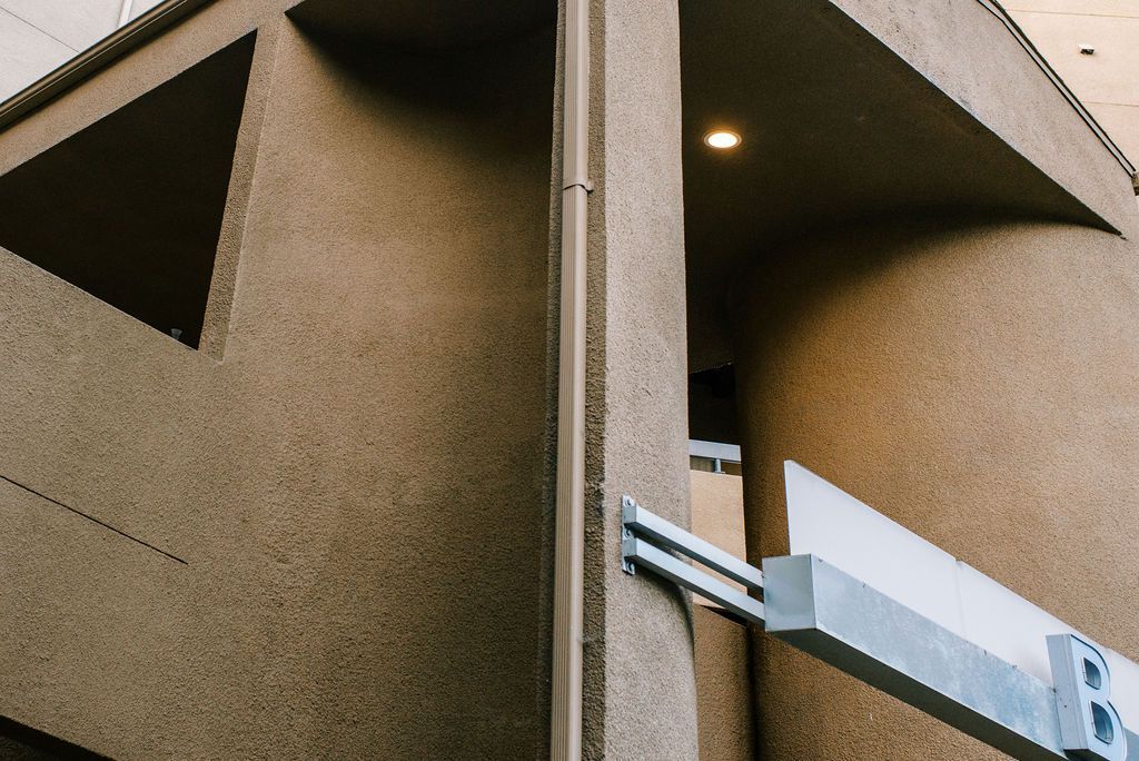 A close up of a concrete building with a balcony