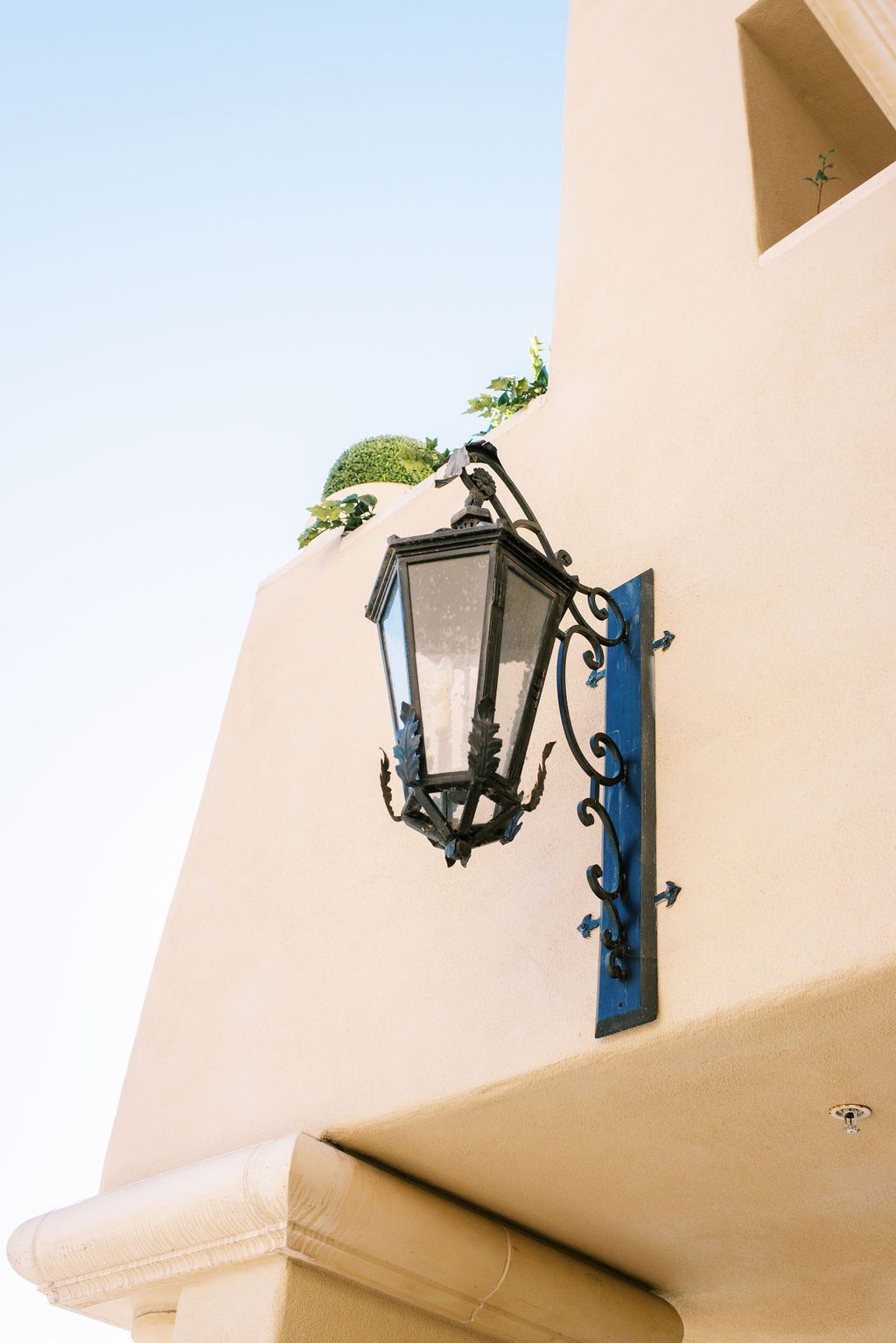 A lantern is hanging on the side of a building