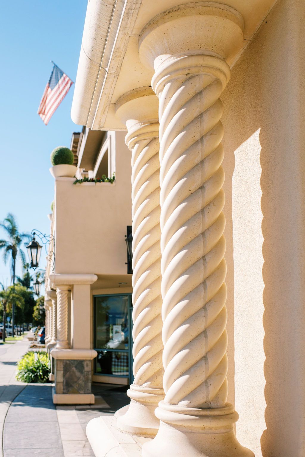 A building with twisted columns and an american flag