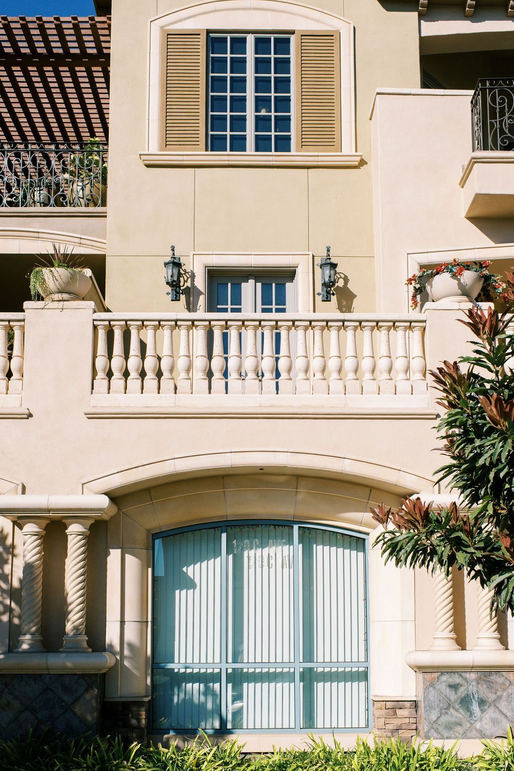 A building with a balcony and a blue door