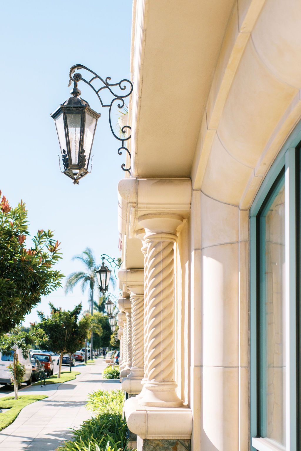 A street light is hanging from the side of a building.