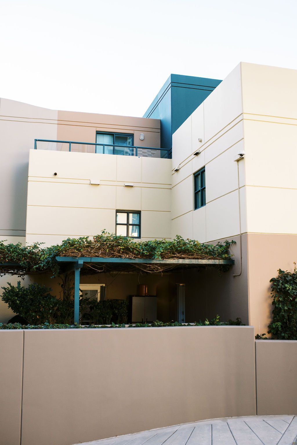 A building with a pergola on the side of it