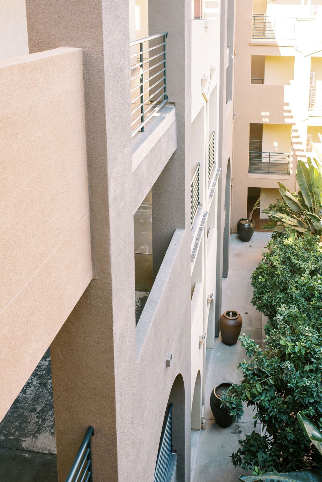 An aerial view of a building with balconies and potted plants