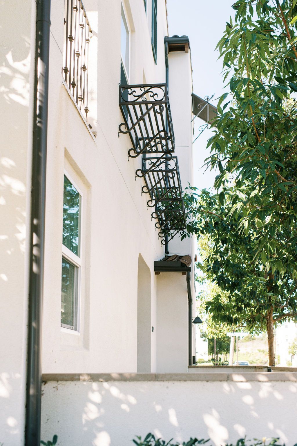 A white building with a balcony on the side of it.