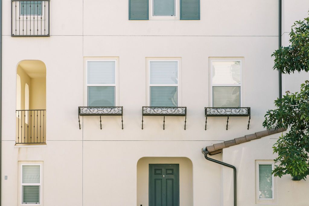 A white building with a green door and windows