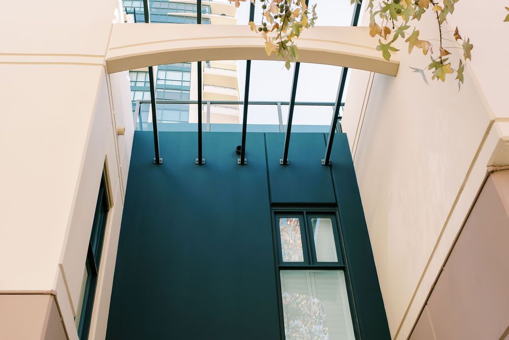 Looking up at a building with a balcony and a window.