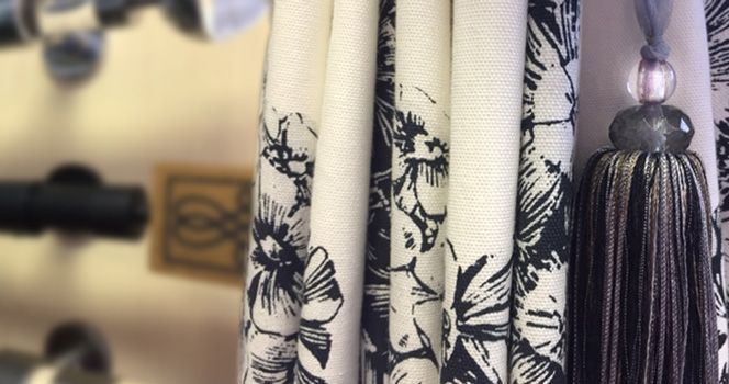 Draped floral curtains with a tassel, in black and white.