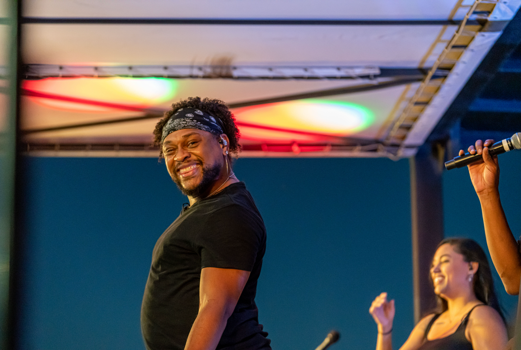 Professional event photography capturing live entertainment during an outdoor corporate celebration.