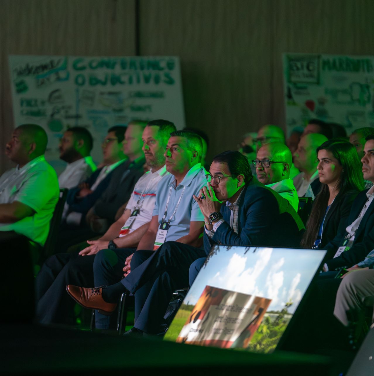 Conference attendees engaged during a keynote presentation at a corporate event.