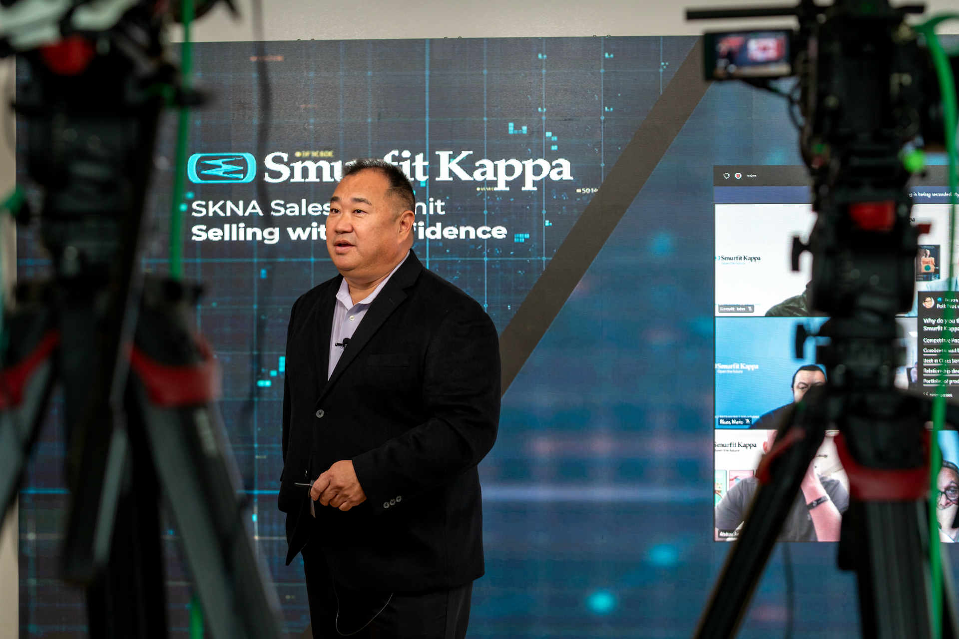 Presenter delivering a hybrid conference session streamed live to both in-person and virtual attendees.