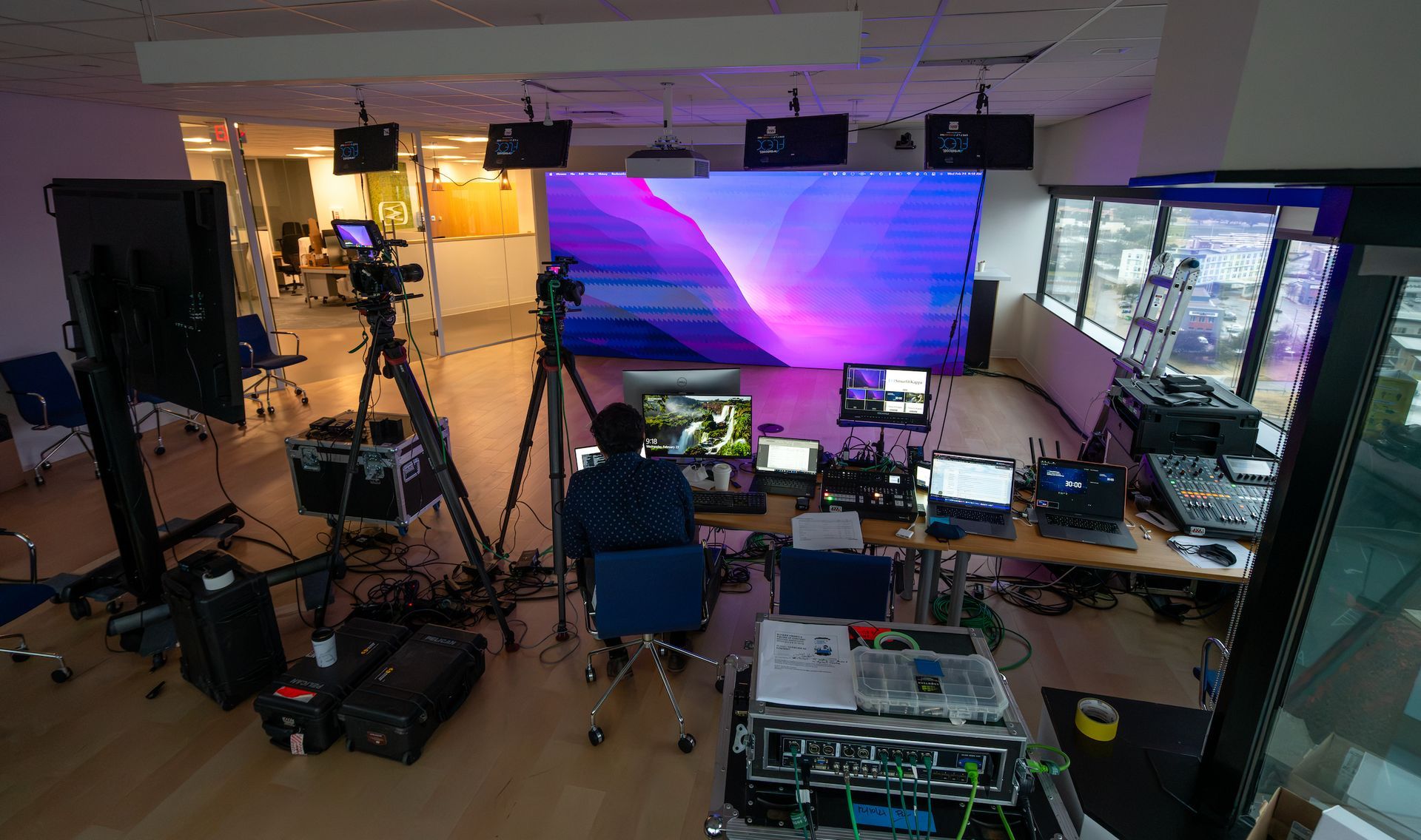 Multi-camera live streaming control room with LED video wall for a corporate broadcast.