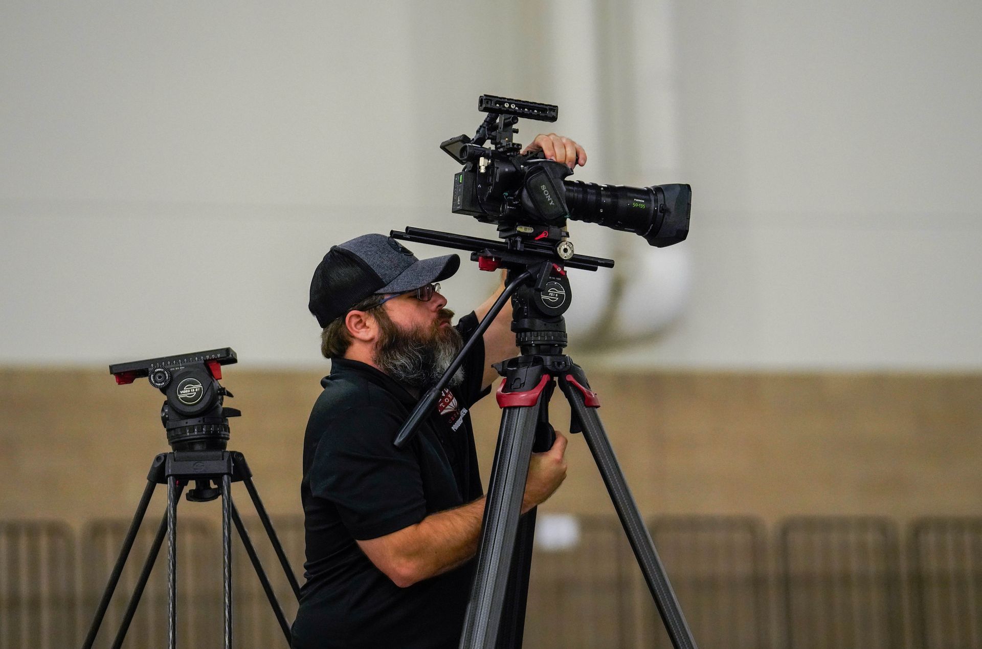 Professional camera operator capturing live event footage with a broadcast-quality cinema camera.