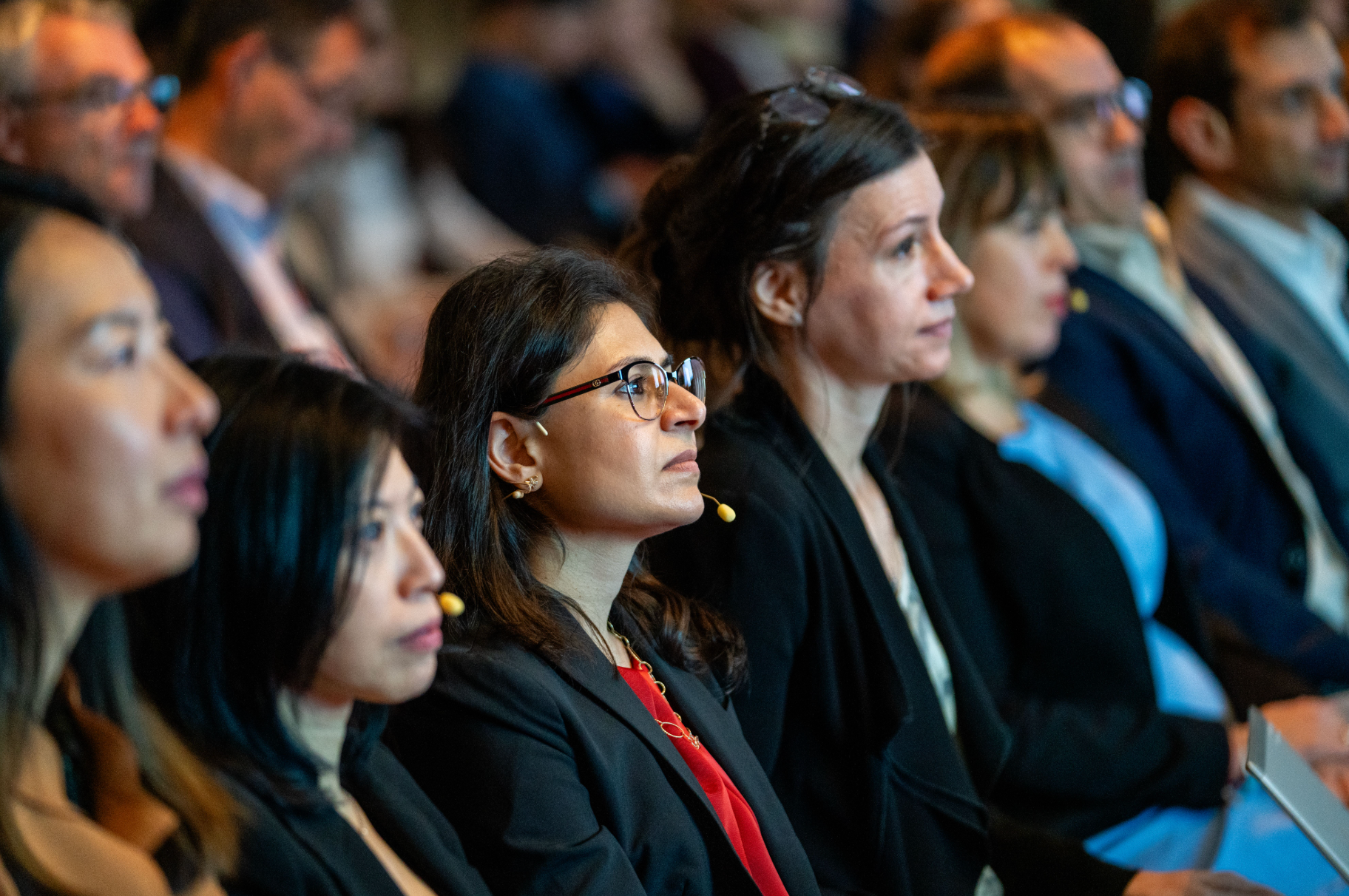 Professional event photography capturing attendee engagement during a corporate conference keynote.