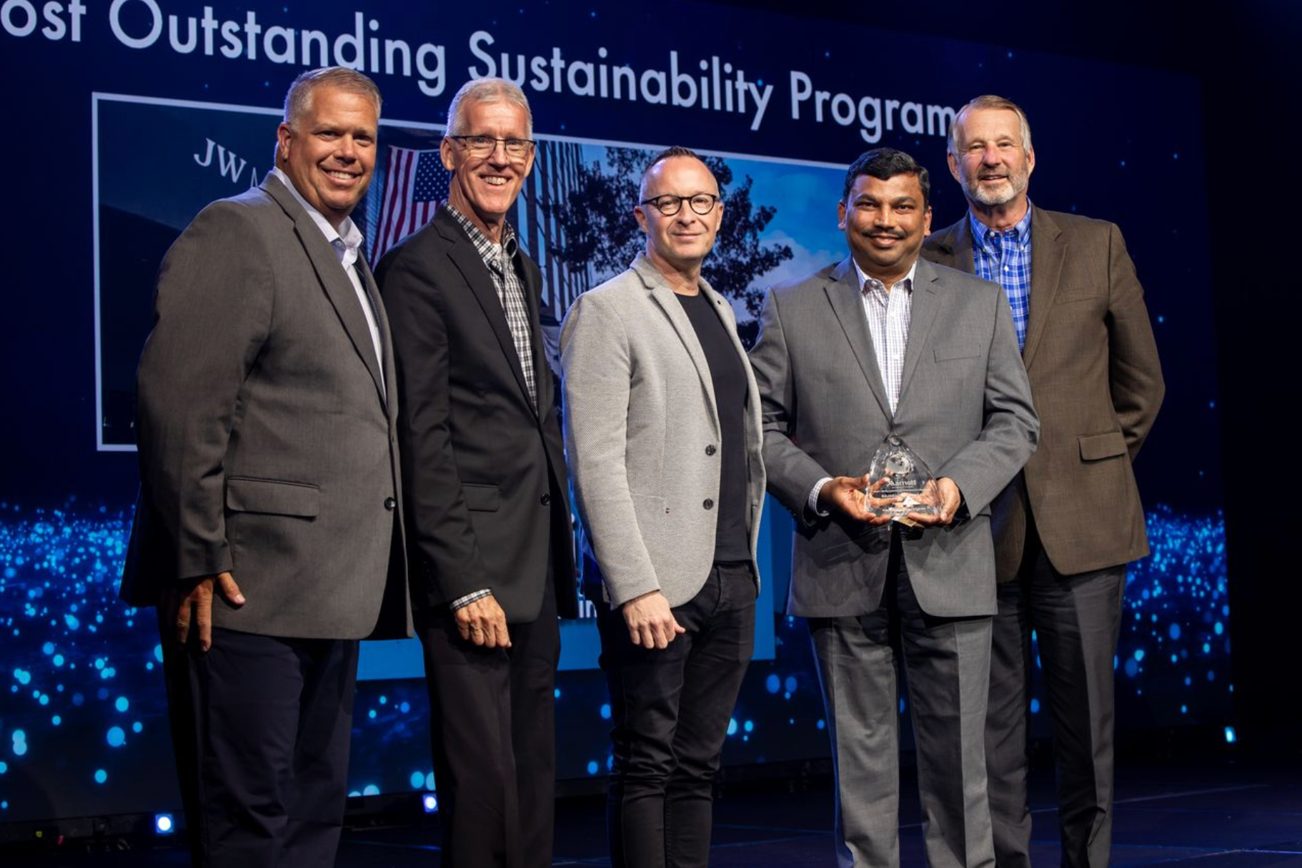 Professional event photography capturing a corporate awards presentation honoring outstanding achievement.