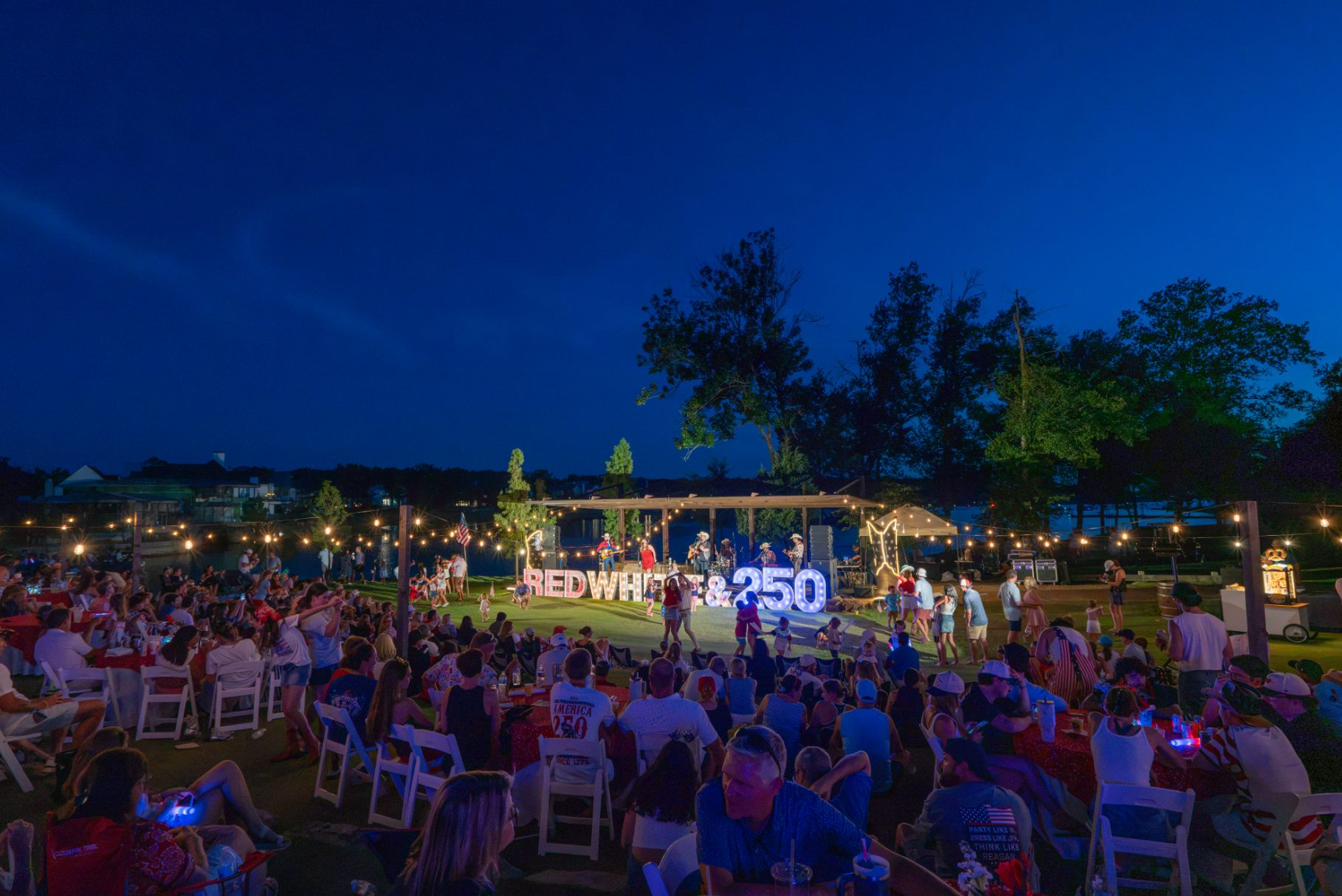 Professional event photography capturing guests and live entertainment during an outdoor corporate celebration.