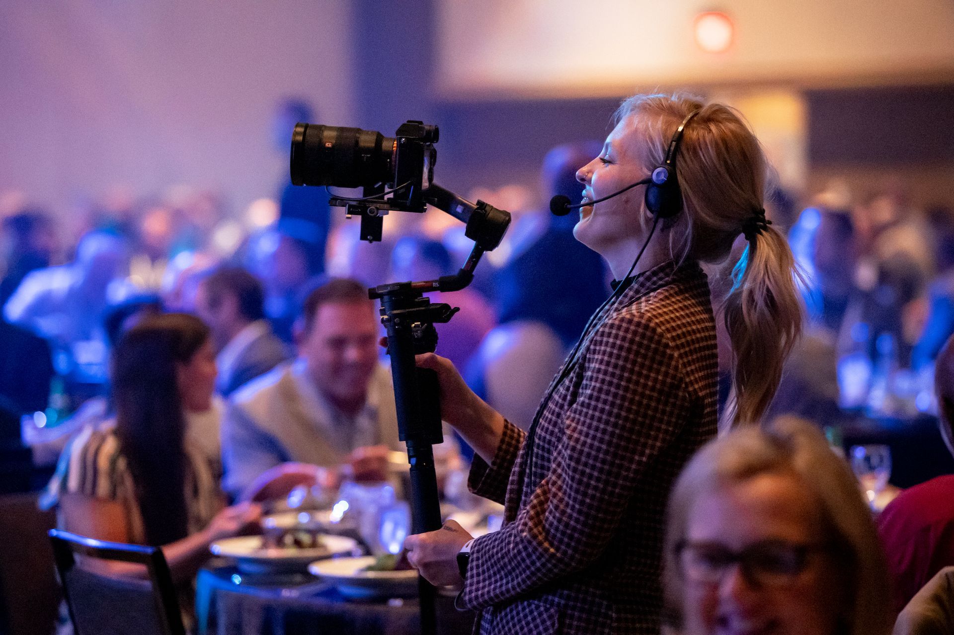 Behind-the-scenes event producer coordinating live coverage to ensure a seamless attendee experience.