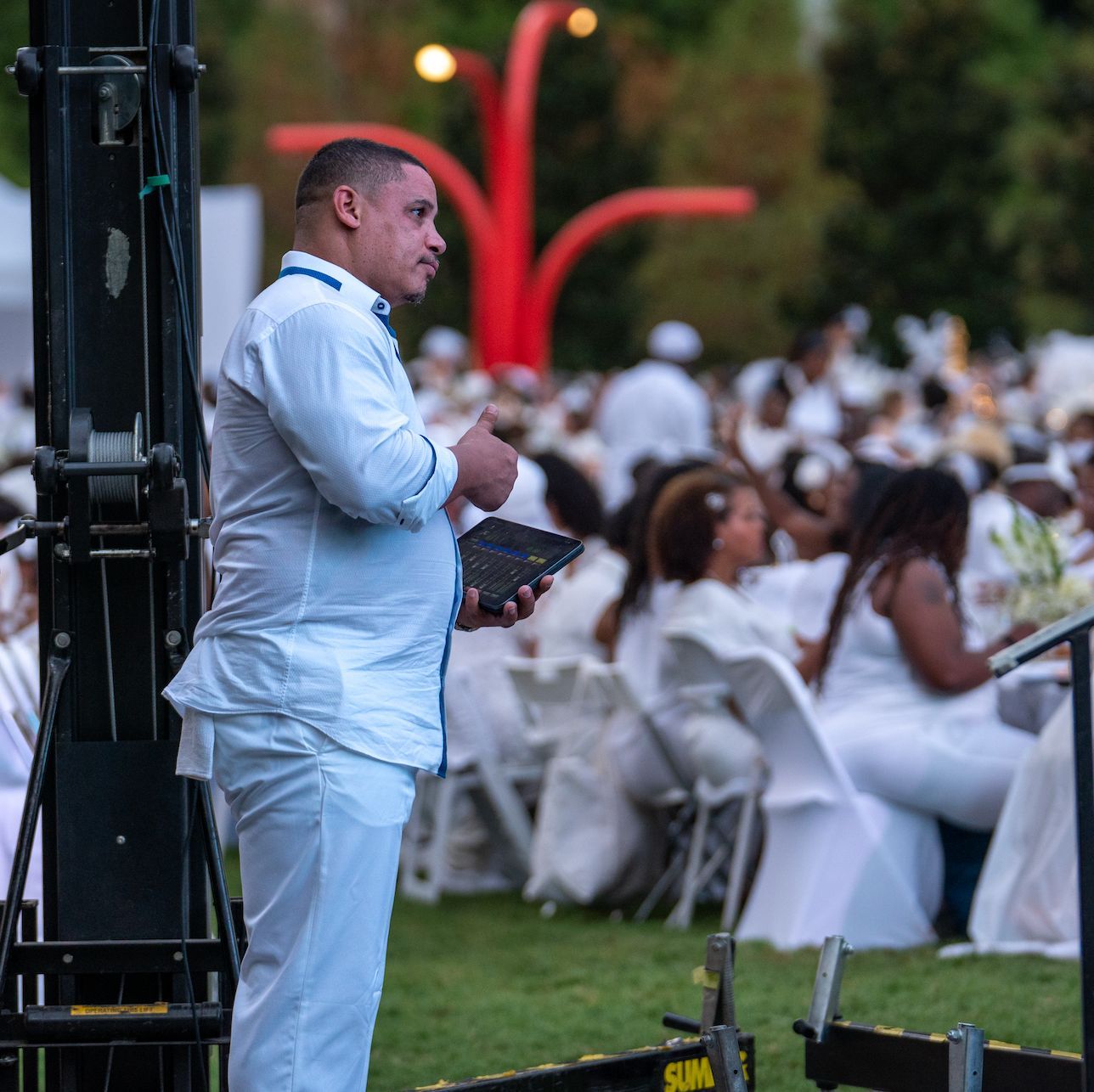 Event producer managing show operations during an outdoor corporate event.