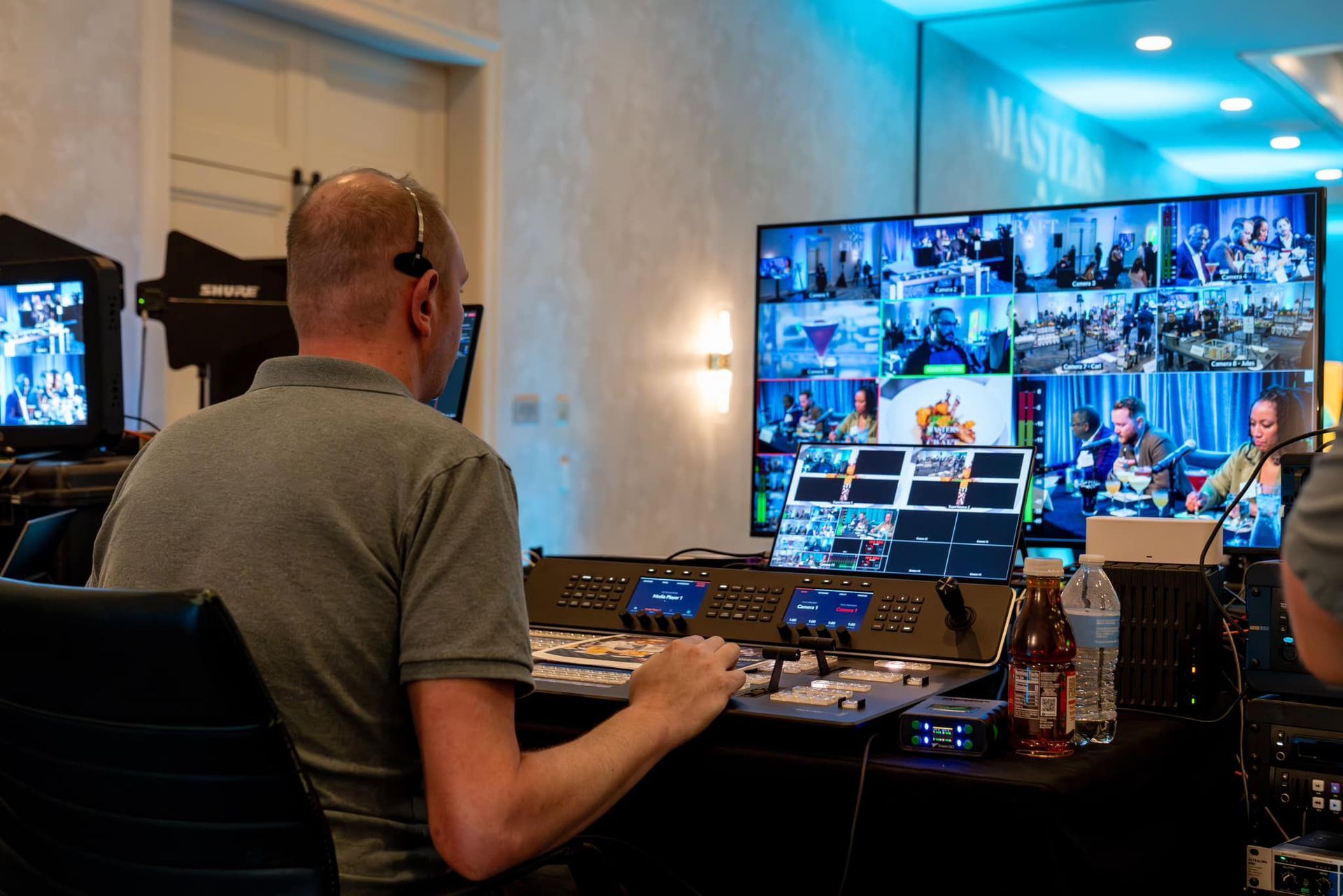 Live streaming production team managing a multi-camera broadcast for a hybrid corporate event.