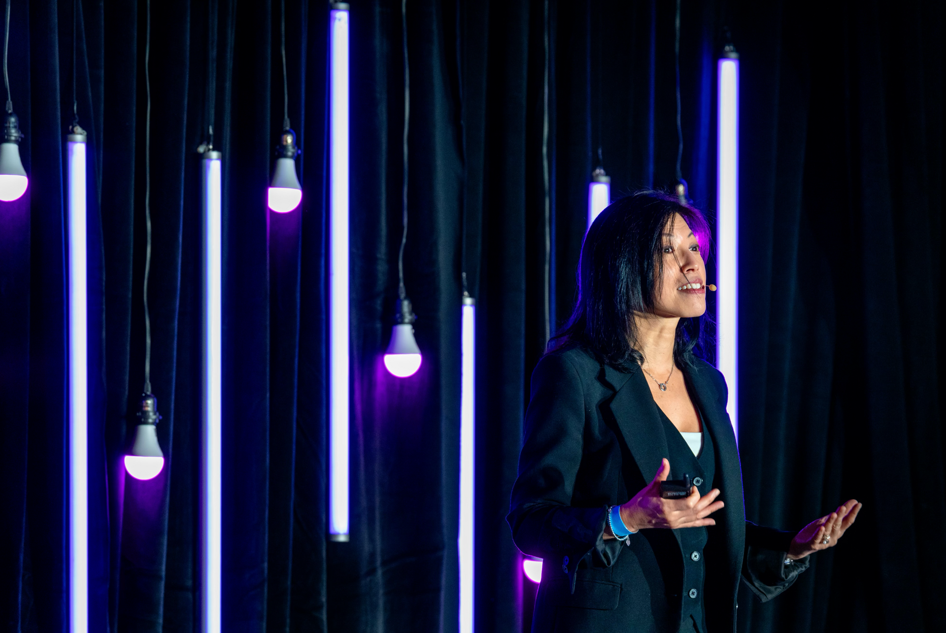 Professional event photography capturing a keynote speaker on a custom conference stage.