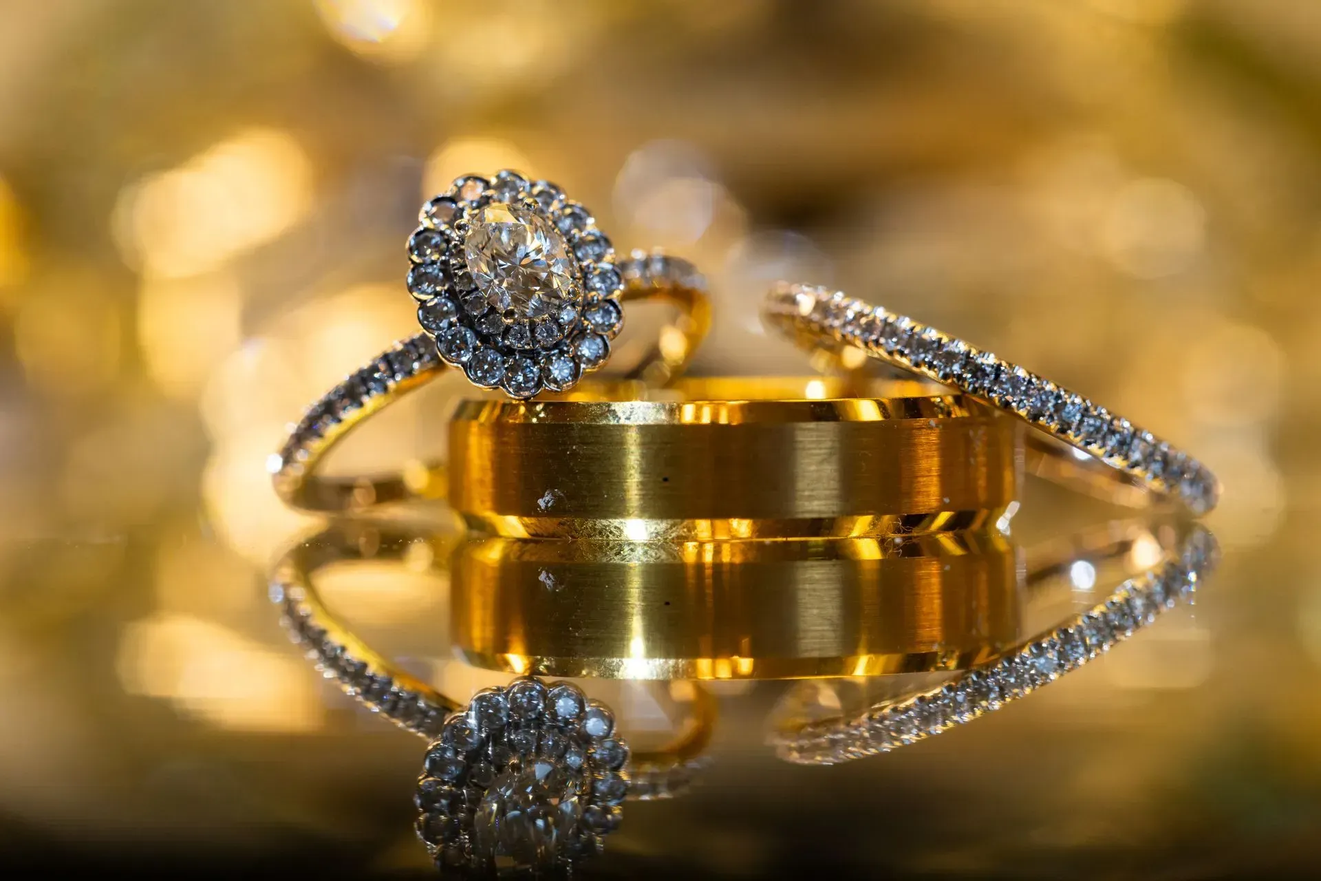A close up of a wedding ring and engagement ring on a table.