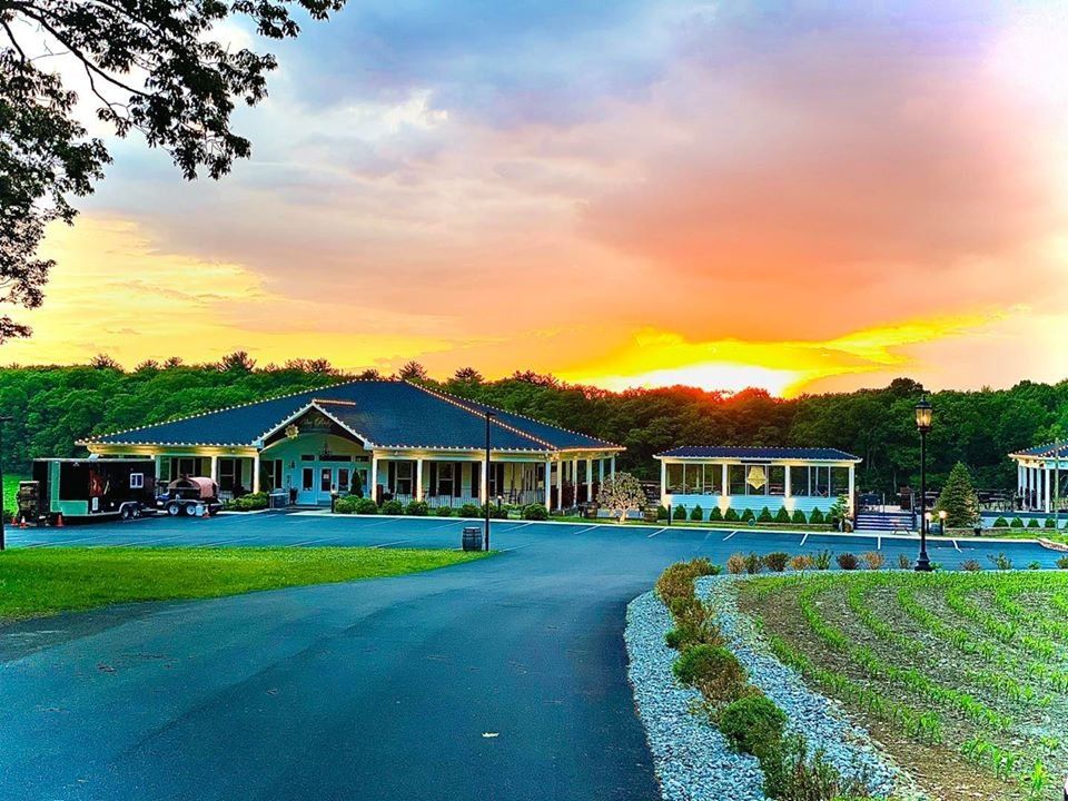A large house with a sunset in the background