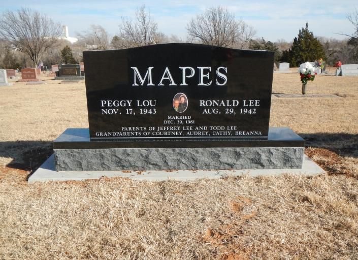 Black granite Mapes family gravestone in a cemetery, with two engraved names and dates.