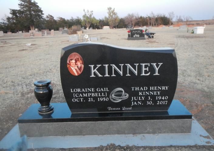 Kinney family gravestone in a cemetery, black granite headstone with engraved names and dates.