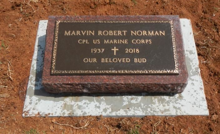 Marvin Robert Norman memorial plaque on a white stone base, engraved with Marine Corps service and dates.