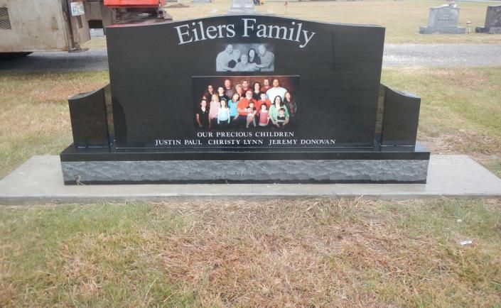 Black Eilers Family granite memorial with a photo inset, set on a concrete base in a grassy area.