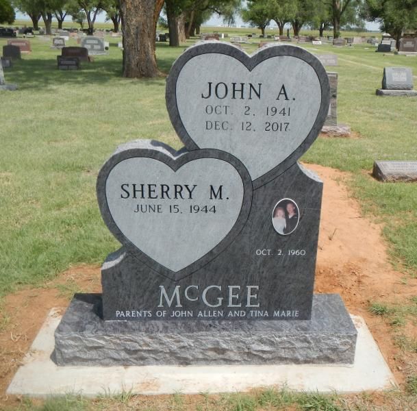 Two heart-shaped gravestones in a cemetery for John A. and Sherry M. McGee