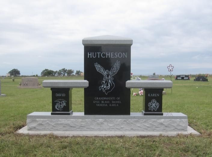 Black Hutcheson memorial headstone with eagle engraving in a grassy cemetery