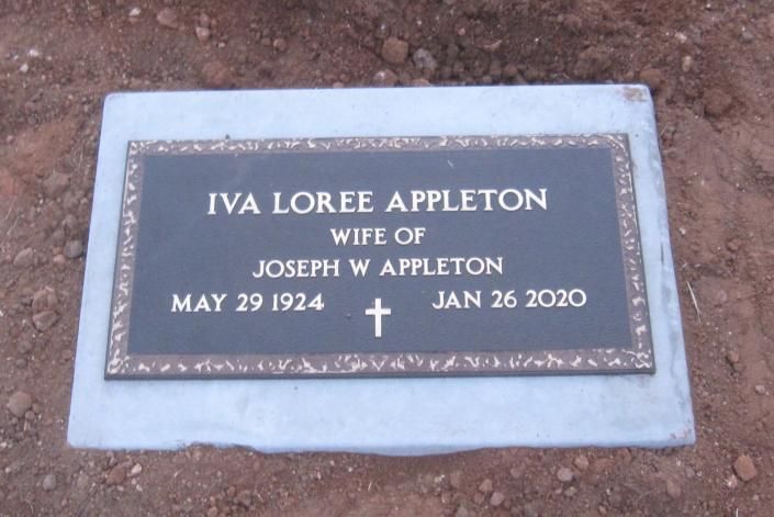 Gravestone plaque reading “Iva Loree Appleton,” with birth and death dates, set in a stone border.