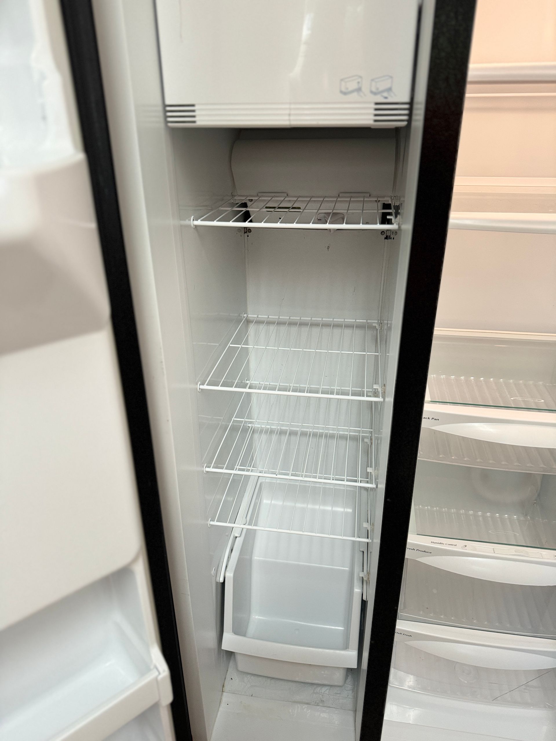 The inside of an empty refrigerator with the door open