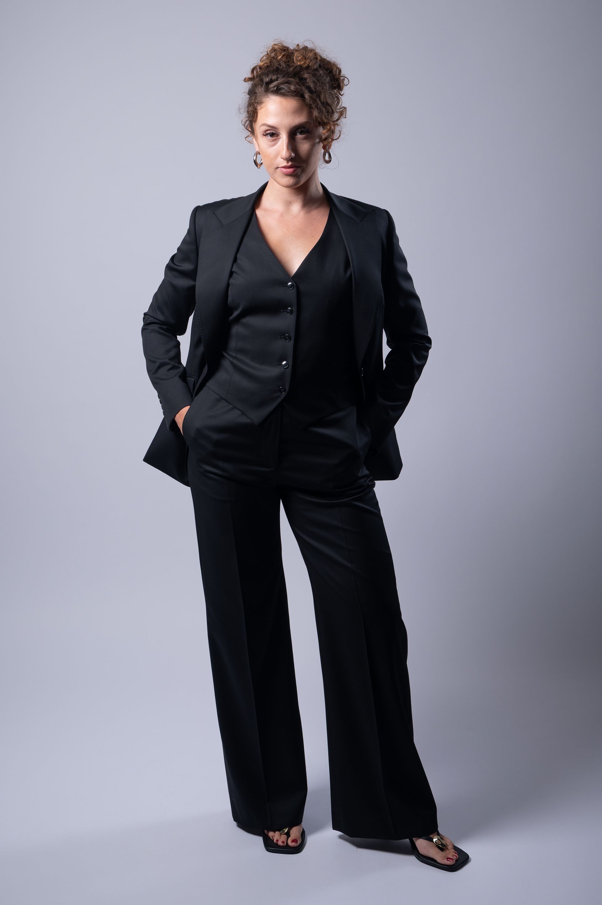 Lady in made to measurer black three piece suit in Edward George Cotswolds tailoring studio