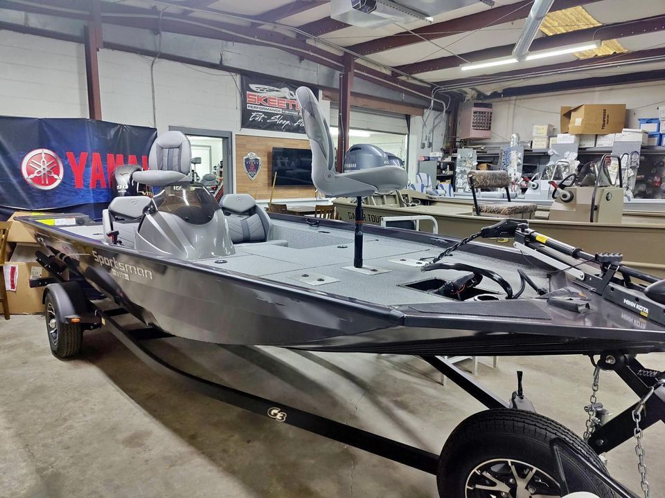 A boat is sitting on a trailer in a garage.