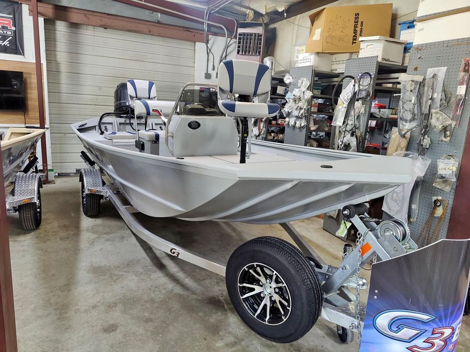 A boat is sitting on a trailer in a garage.