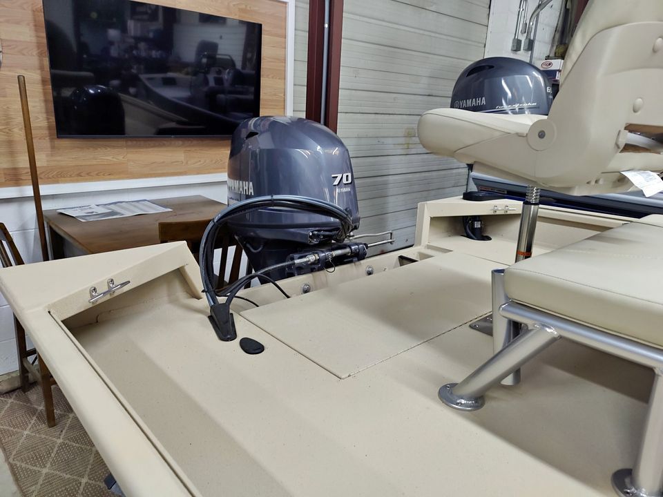 A boat with a motor and a seat in a room.
