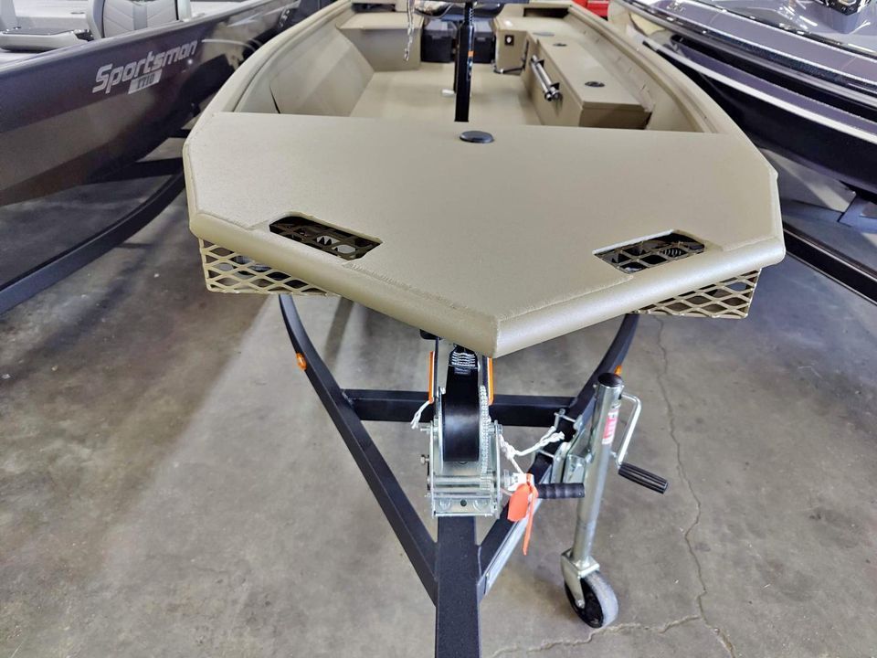 A boat is sitting on a trailer in a warehouse.