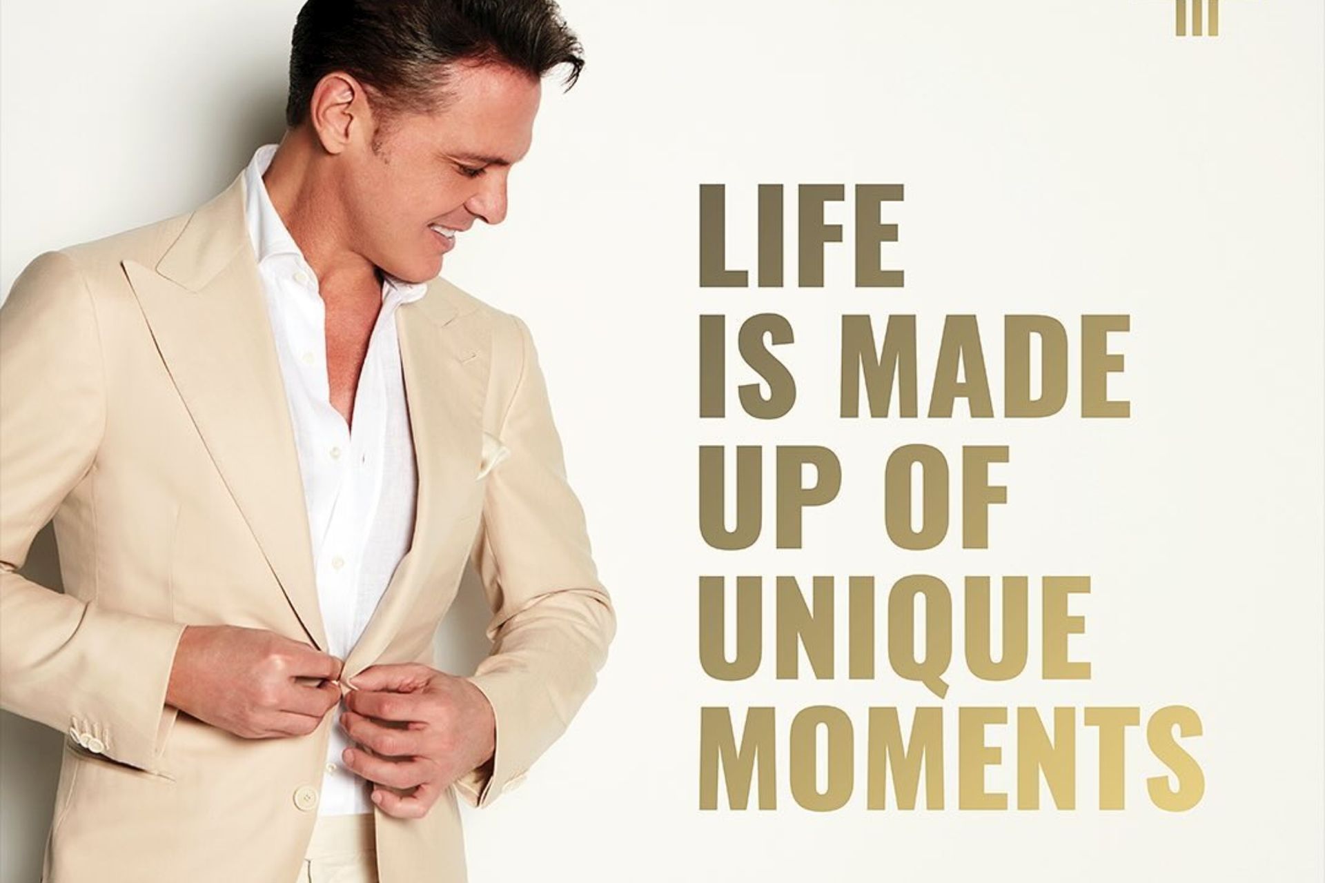 Man in beige suit, smiling, buttoning jacket. Text: 