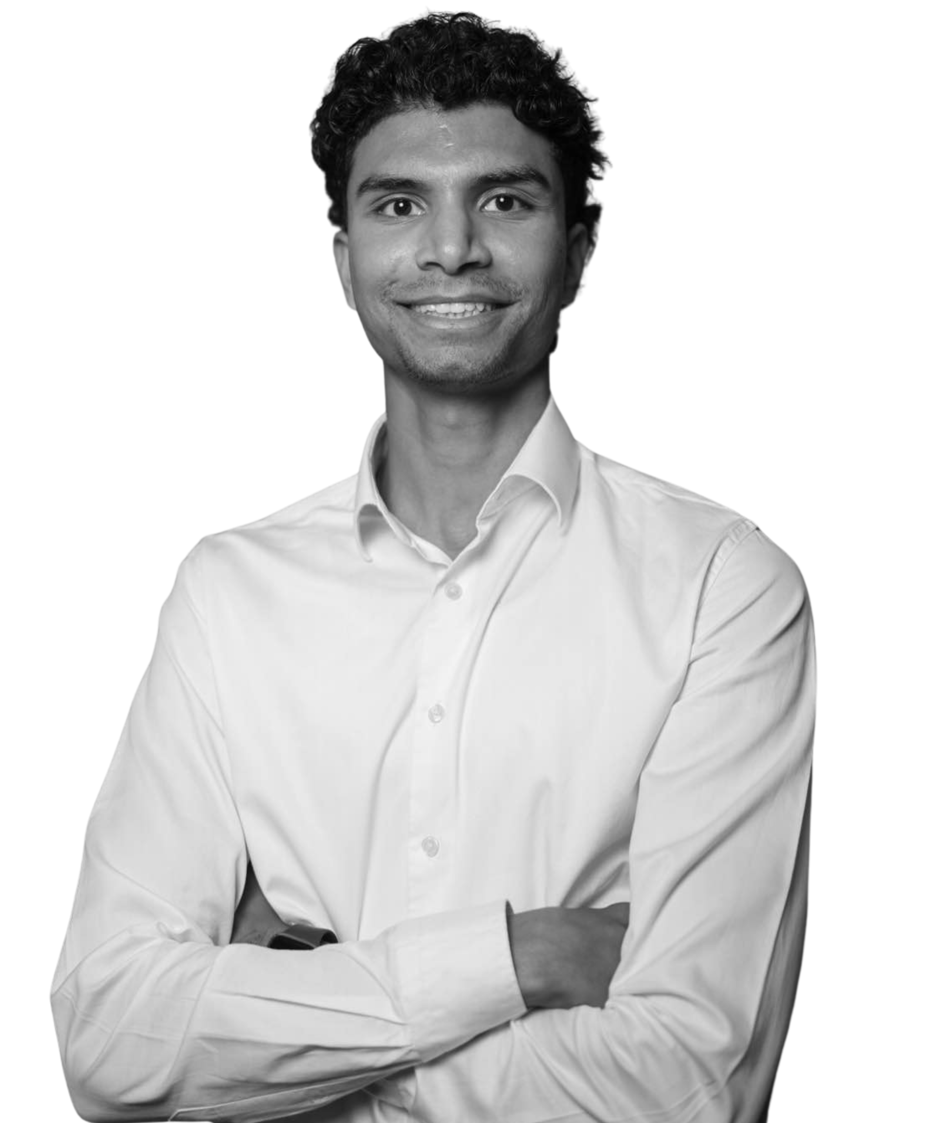 A man in a suit and tie is smiling in a black and white photo