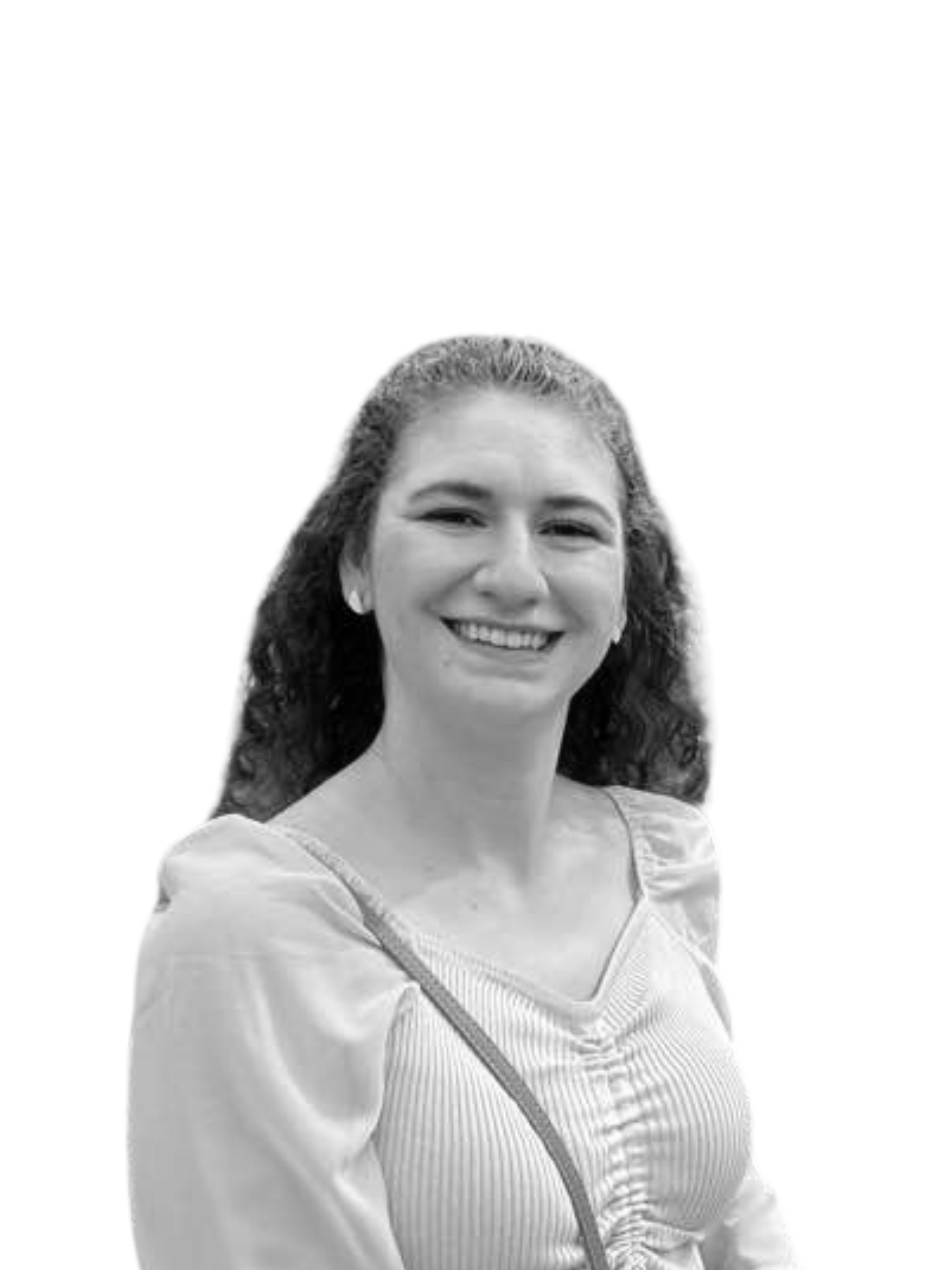 A woman with curly hair is smiling in a black and white photo.