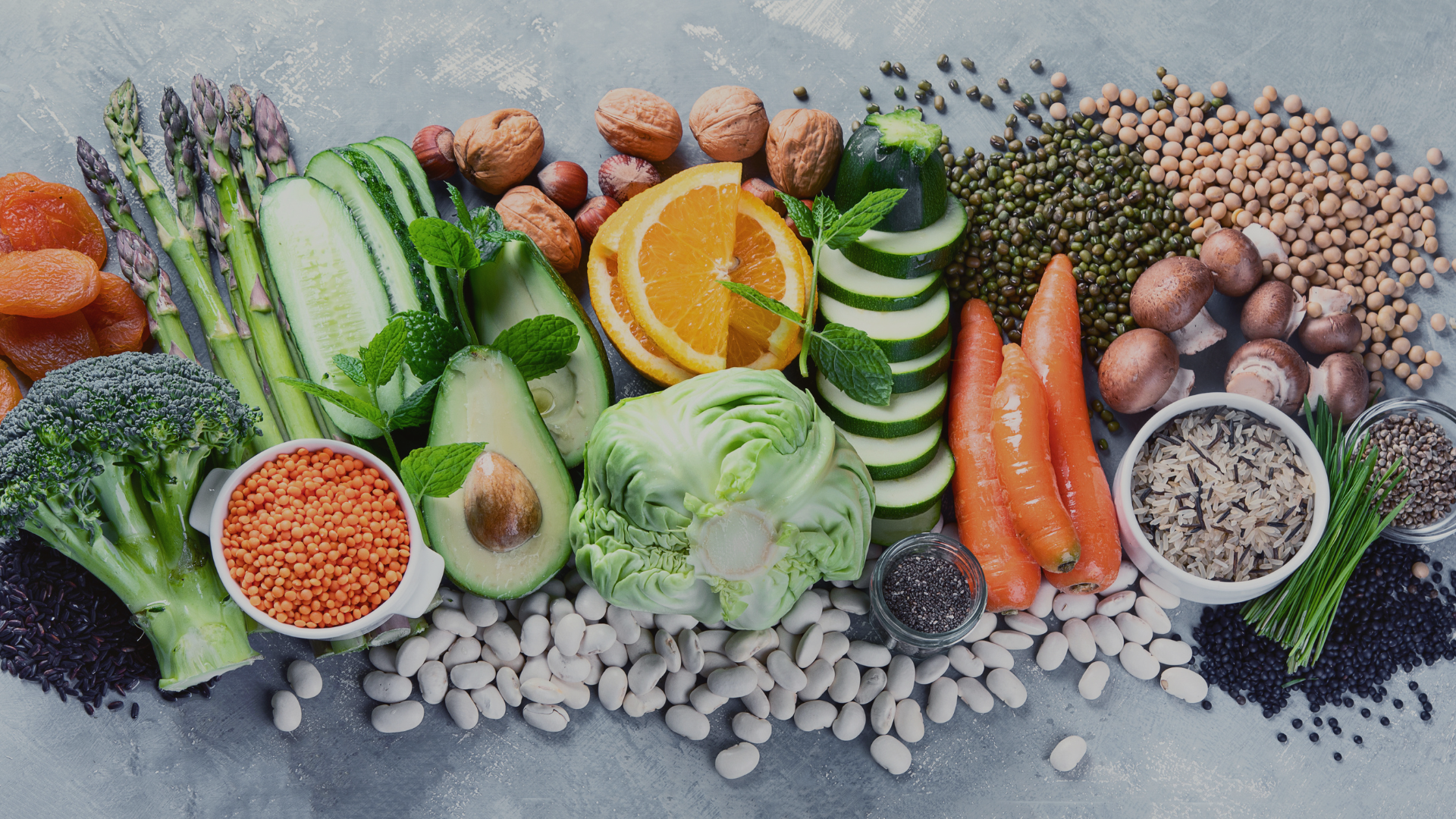 There are many different types of vegetables and beans on the table.