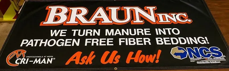 A braun inc sign that says we turn manure into pathogen free fiber bedding