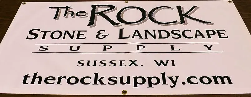 A sign for the rock stone and landscape supply in sussex wi