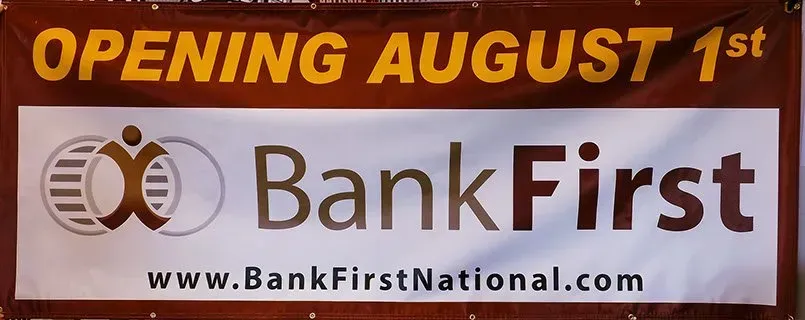 A bank first sign that says opening august 1st