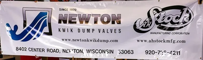 A banner for newton erik dump valves hangs on a wall