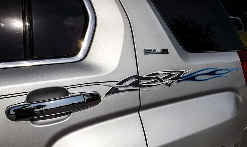 A silver suv with the word slt on the side