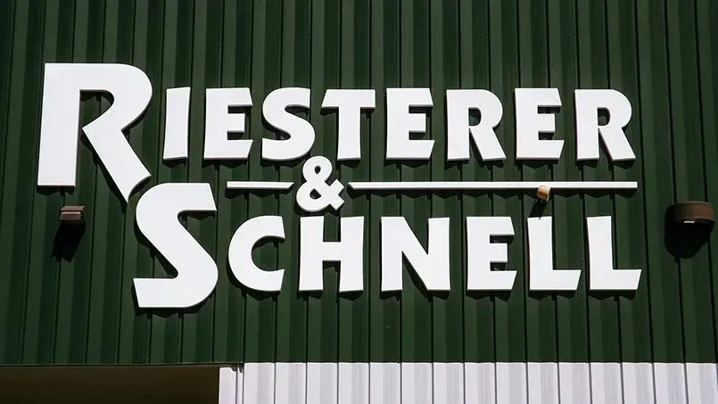 Riesterer & schnell sign on a green building
