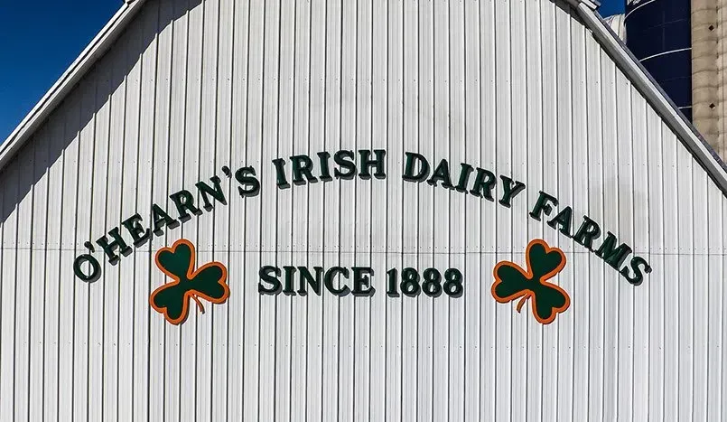 A white barn with the words o'hearn 's irish dairy farms since 1888 painted on it